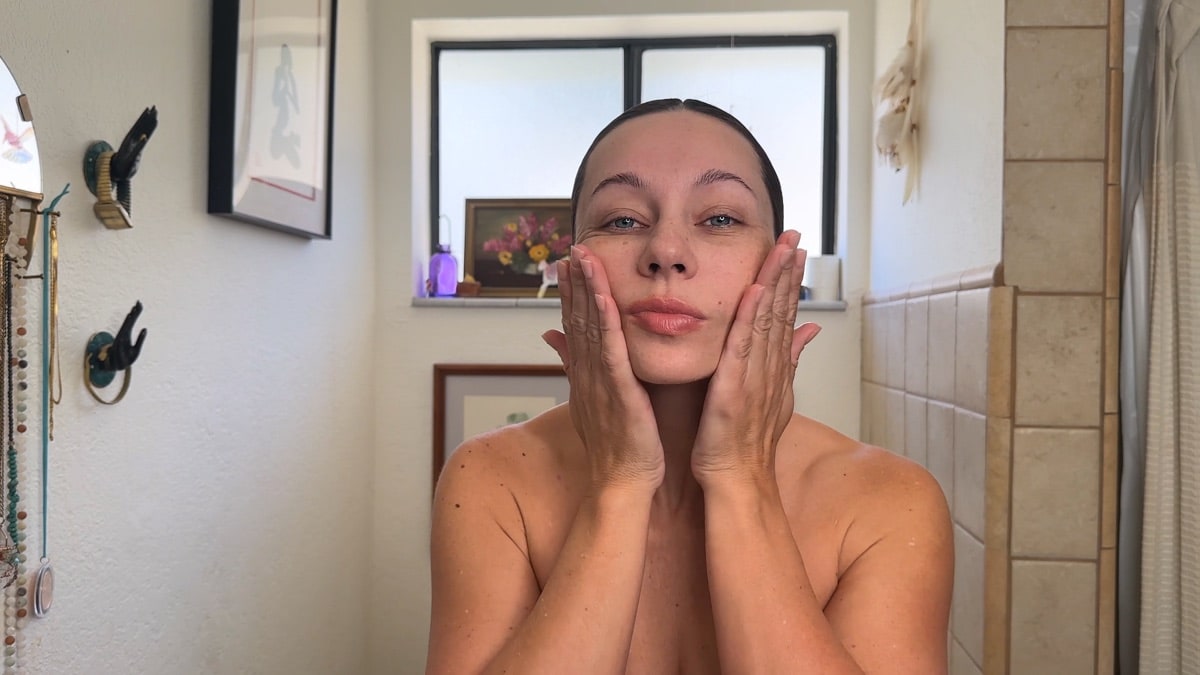Shannon demonstrating a facial massage movement with her hands
